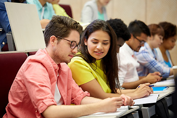 Image showing group of international students writing at lecture