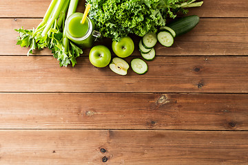 Image showing close up of jug with green juice and vegetables