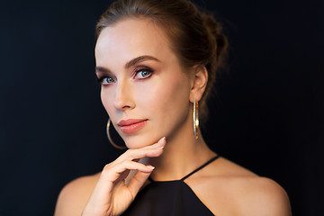 Image showing beautiful woman in black wearing diamond jewelry