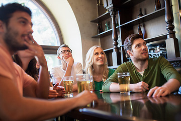 Image showing friends with beer watching football at bar or pub