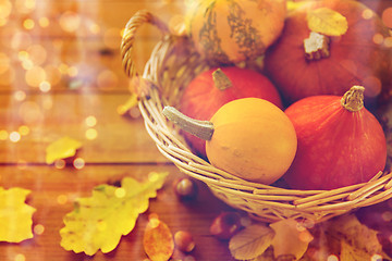 Image showing close up of pumpkins in basket on wooden table