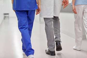 Image showing group of medics or doctors walking along hospital