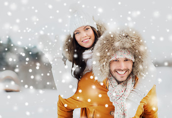 Image showing happy couple having fun over winter background