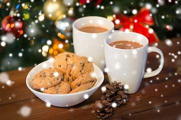 Image showing oat cookies and hot chocolate over christmas tree