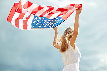 Image showing happy young woman with american flag outdoors