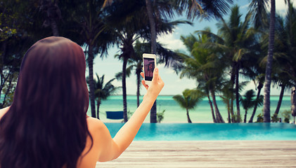 Image showing young woman taking selfie with smartphone