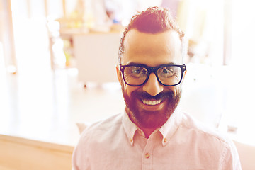 Image showing smiling man with eyeglasses and beard at office