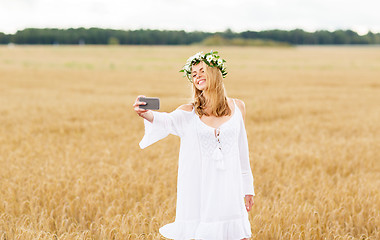 Image showing happy young woman taking selfie by smartphone