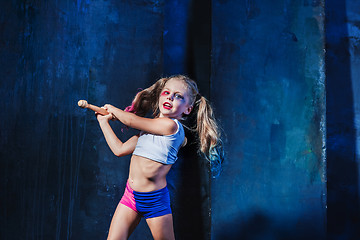 Image showing Halloween theme: Girl with baseball bat ready to hit