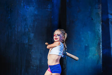 Image showing Halloween theme: Girl with baseball bat ready to hit