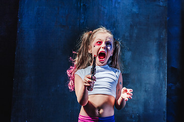 Image showing Little girl pointing in toy gun