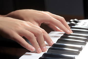 Image showing Girl\'s hands on the keyboard of the piano