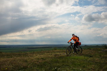 Image showing Young man is riding bicycle outside. Healthy Lifestyle.