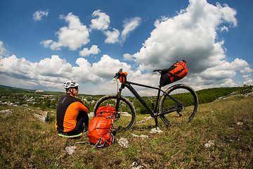 Image showing View of a Young Man With Bicycle on Summer Background.