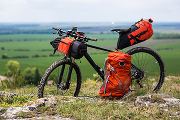 Image showing Bicycle with orange bags for travel