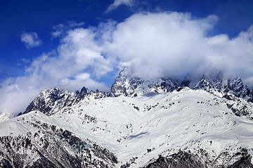 Image showing Snow mountains in fog at sun winter day