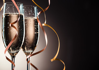 Image showing Elegant image closeup of two champagne glasses and decorative ribbons