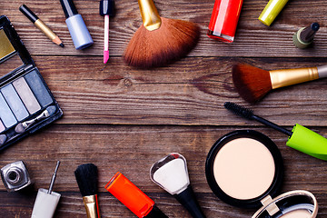 Image showing Makeup cosmetics, brushes and other on brown background