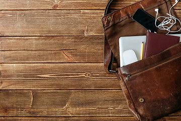 Image showing Leather bag with gadgets and notebooks