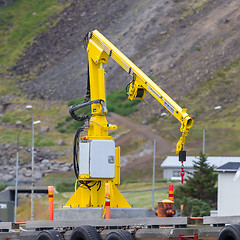 Image showing Fishing crane in small seaside Iceland town harbor