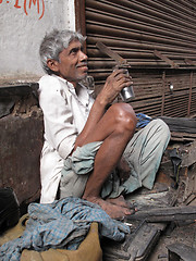 Image showing Streets of Kolkata. Shoe shiner waiting for a customer