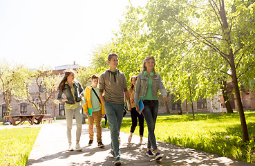 Image showing group of happy teenage students walking outdoors