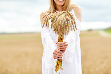 Image showing close up of happy woman with cereal spikelets