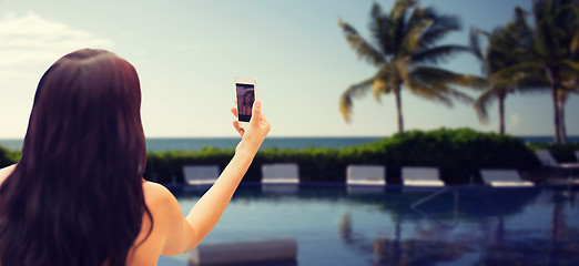 Image showing young woman taking selfie with smartphone