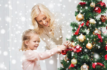 Image showing happy family decorating christmas tree at home