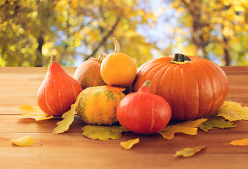 Image showing close up of pumpkins on wooden table outdoors