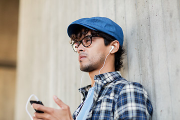 Image showing man with earphones and smartphone listening music