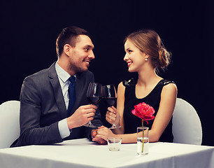 Image showing young couple with glasses of wine at restaurant