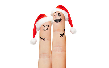 Image showing close up of two fingers with smiley and santa hats