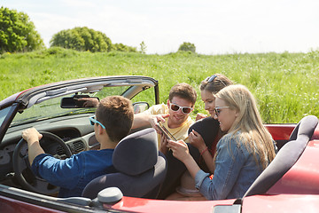 Image showing friends with tablet pc driving in cabriolet car