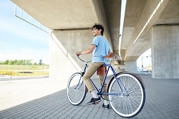 Image showing young hipster man riding fixed gear bike