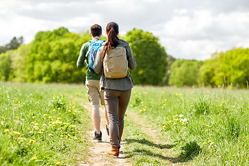 Image showing happy couple with backpacks hiking outdoors