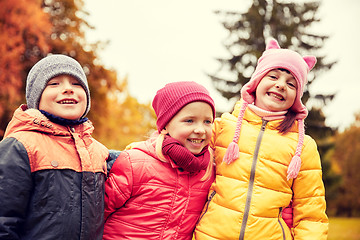 Image showing group of happy children hugging in autumn park