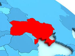 Image showing Ukraine in red on blue globe
