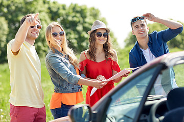 Image showing happy friends driving in cabriolet car