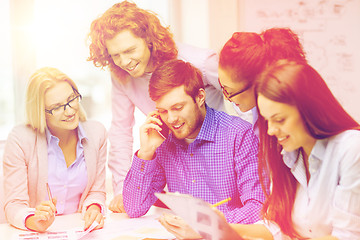 Image showing creative team with papers and clipboard at office