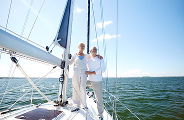 Image showing senior couple hugging on sail boat or yacht in sea