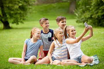 Image showing happy kids or friends taking selfie in summer park