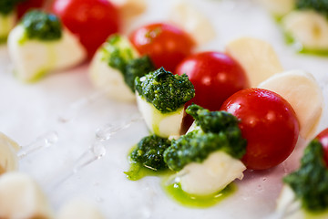 Image showing close up of mozzarella and cherry tomato canape