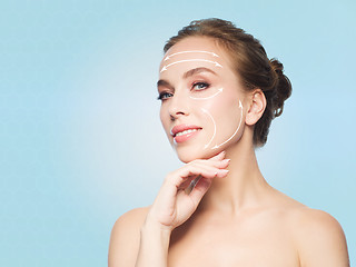 Image showing beautiful young woman touching her face