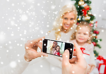 Image showing man taking picture of his family by smatrphone