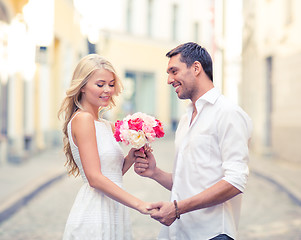 Image showing couple with flowers in the city