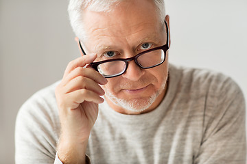 Image showing close up of senior man in glasses thinking