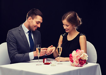 Image showing man proposing to his girlfriend at restaurant