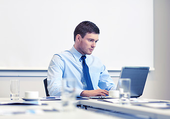 Image showing businessman with laptop working in office