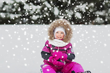 Image showing happy little kid on sled outdoors in winter